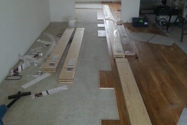 Landhausdiele Eiche im Neubau verlegt Holzboden und Materialien zur Verlegung auf einem unvollendeten Boden.